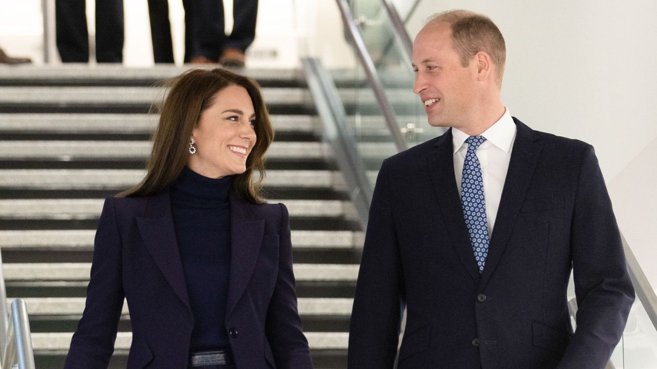 The Prince and Princess of Wales walk down the stairs during an official visit to Boston