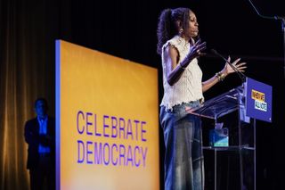 Former first lady Michelle Obama speaks at a When We All Vote rally on October 29, 2024 in College Park, Georgia. With one week until Election Day, top surrogates for Kamala Harris including the Obamas continue to campaign on her behalf in battleground states. she wore a white blouse and jeans