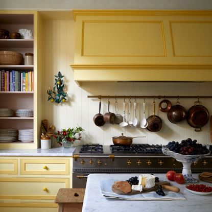 Yellow kitchen cabinets with butter yellow wall panelling