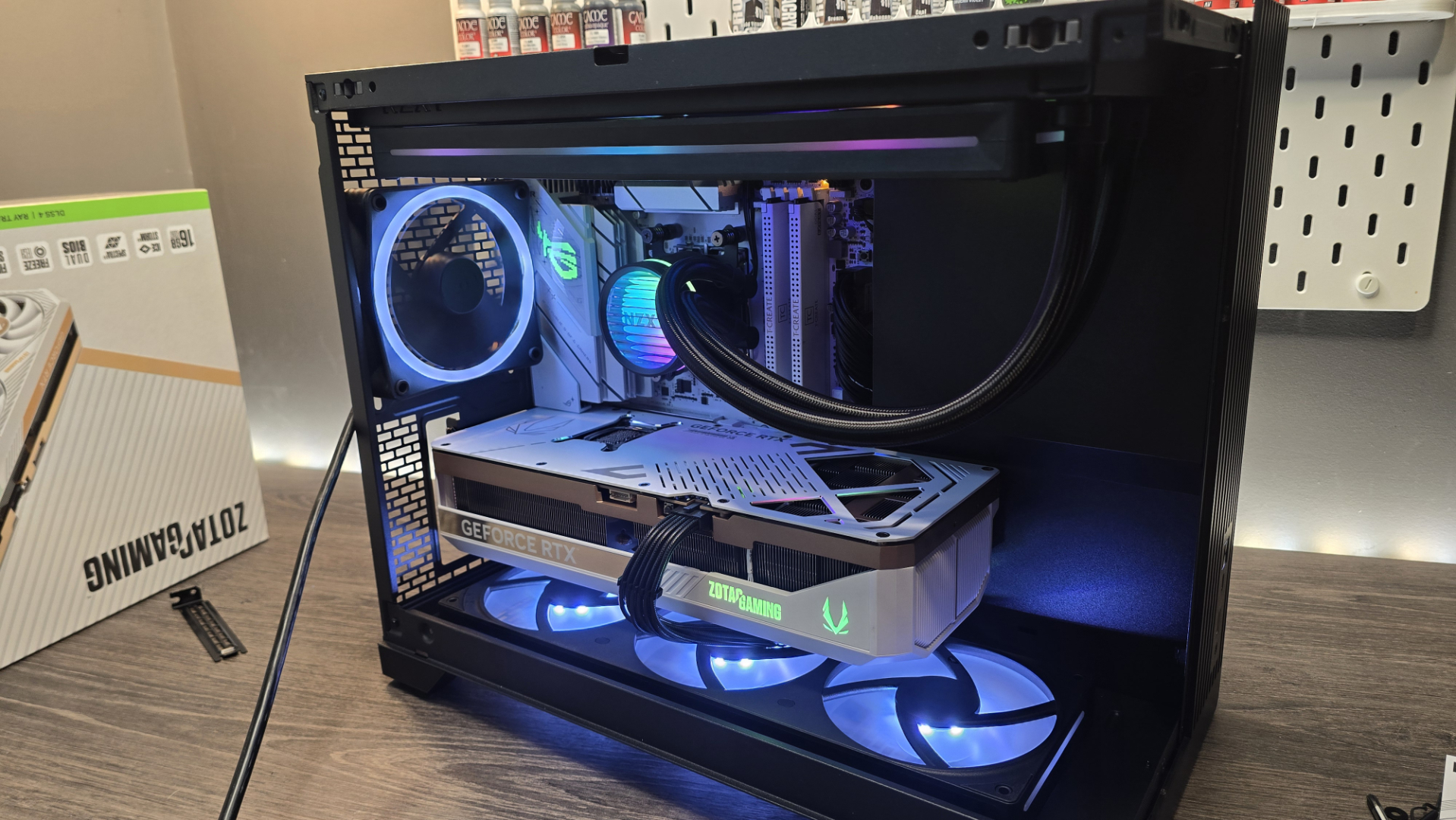 A Phanteks XT V3 PC case on a desk with various PC parts.