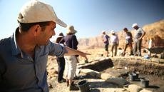Archaeologist Erez Ben-Yosef points to a trench at Slaves' Hill, a copper smelting camp in Timna Valley where recent excavations revealed a gatehouse.