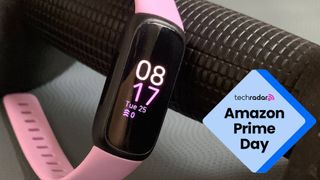Fitbit Inspire 3 resting on a dumbbell