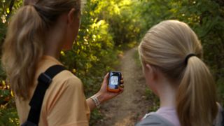 Two young girls navigating using Garmin eTrex SE device