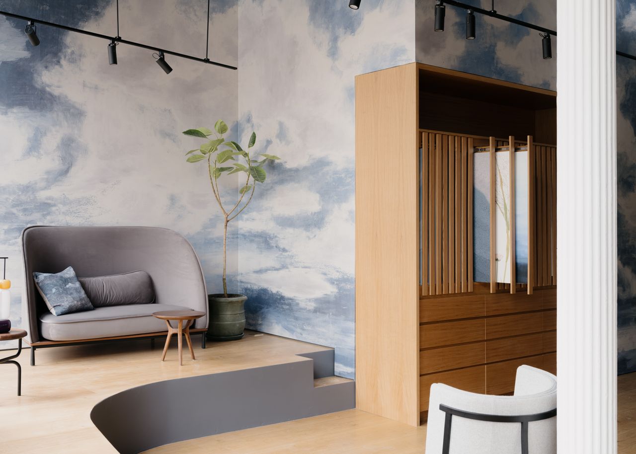 A view of Calico Wallpaper's NYC showroom, where their cloud-like mural is installed on the wall.
