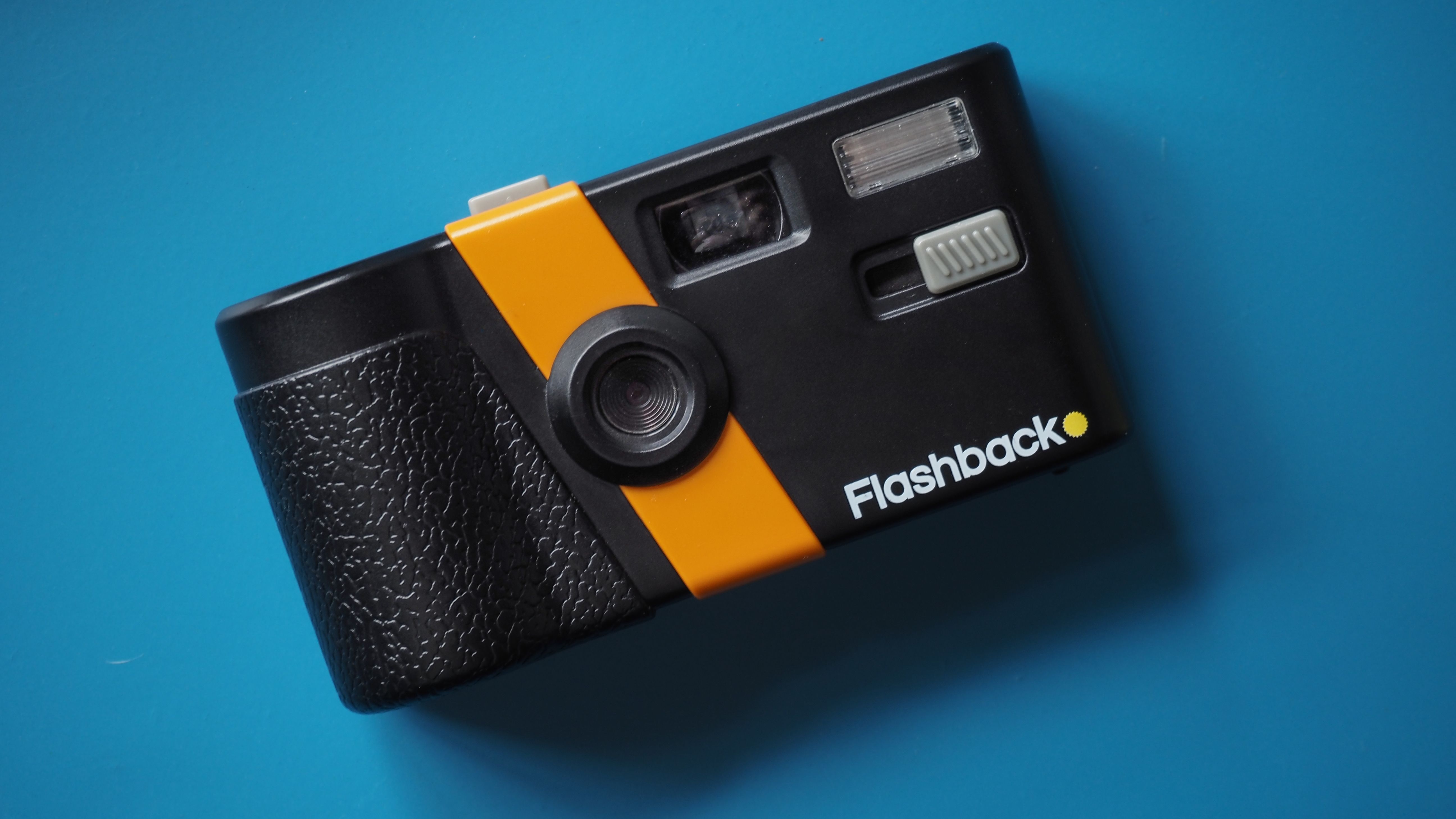 Lifestyle photo of the Flashback camera against a light blue background