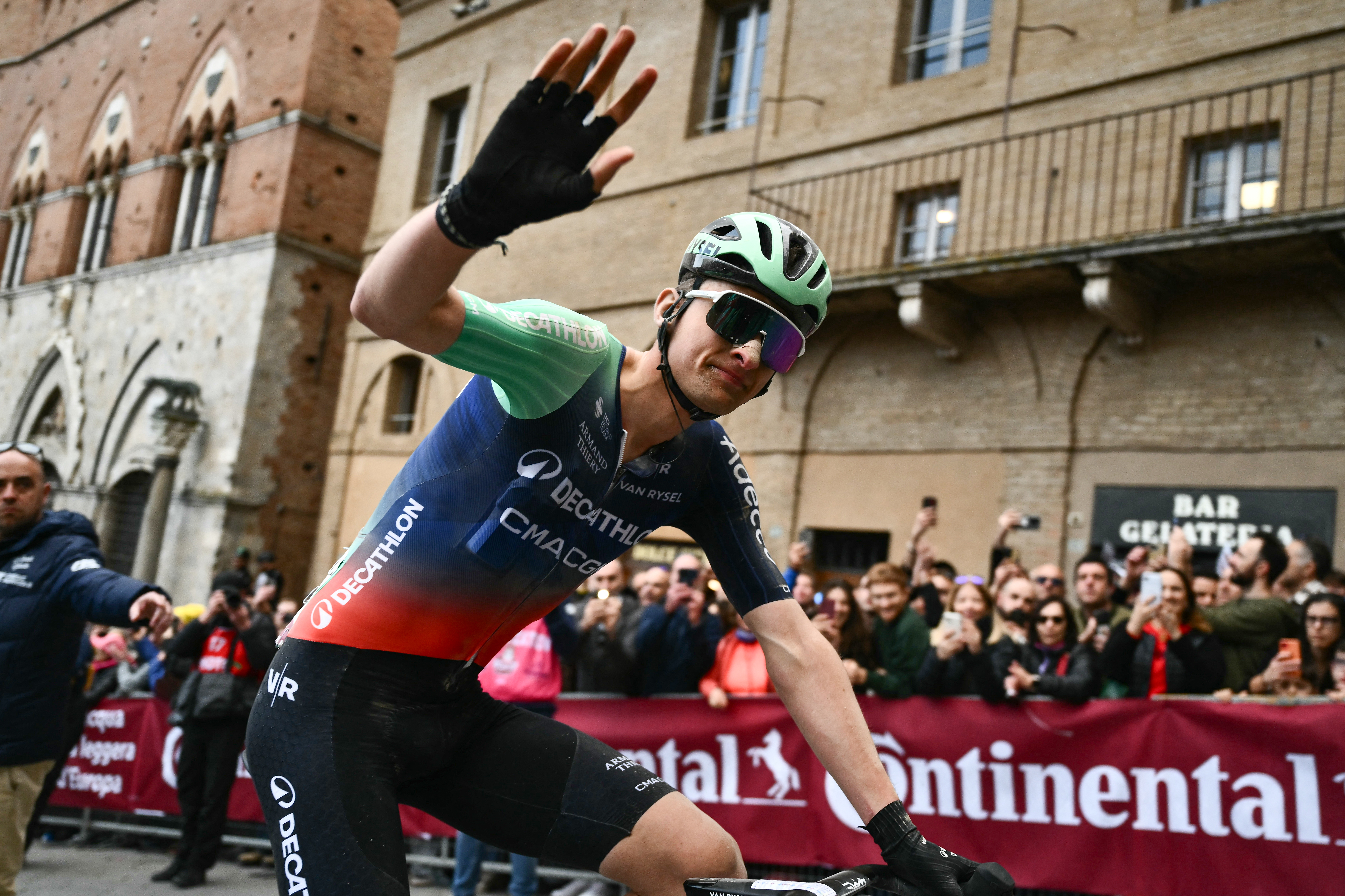 Decathlon CMA CGM Team's French Paul Seixas waves after crossing the finish line to win second place in the 20th one-day classic 'Strade Bianche' (White Roads) men's cycling race between Siena and Siena in Tuscany on March 7, 2026. (Photo by Marco BERTORELLO / AFP)