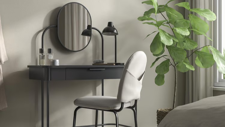 IKEA GR&amp;Aring;FJ&amp;Auml;LLET dressing table in anthracite with oval mirror, styled in a minimal gray bedroom with a lamp and chair