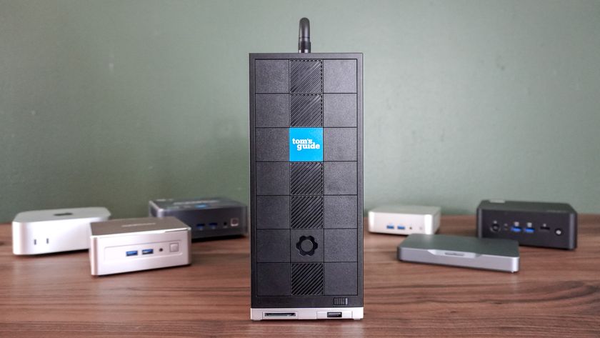 A number of different mini PCs on a desk with the Framework Desktop front and center