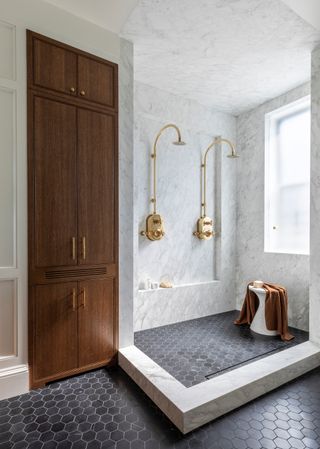 marble double shower with brass hardware