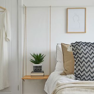 bedroom with plant in pot and bed with pillows