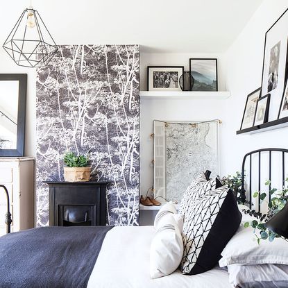 bedroom with wallpaper and frames