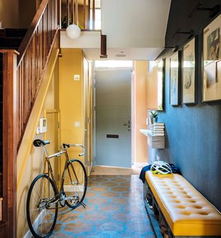 Hallway with yellow and black walls with dark wood flooring