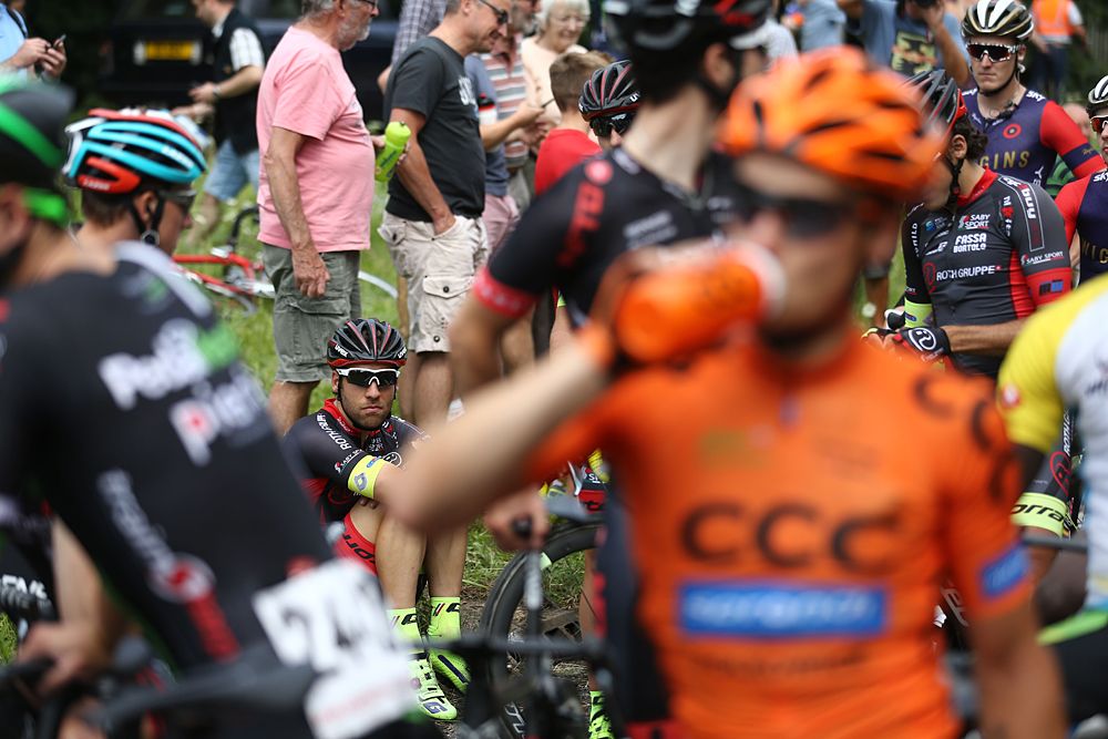 Riders wait for the race to re-start after being neutralized due to a crash up the road in the cyclo-sportif event