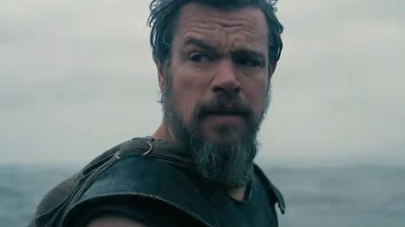 Matt Damon looking back at his men wearing full armour as the ocean looms. 