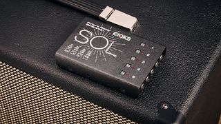 Cioks Sol Future Power Generation power supply sitting on top of a guitar amp