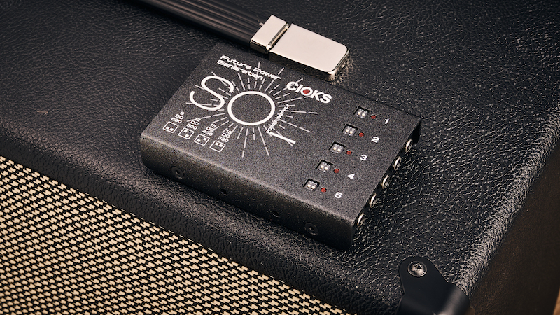 Cioks Sol Future Power Generation power supply sitting on top of a guitar amp
