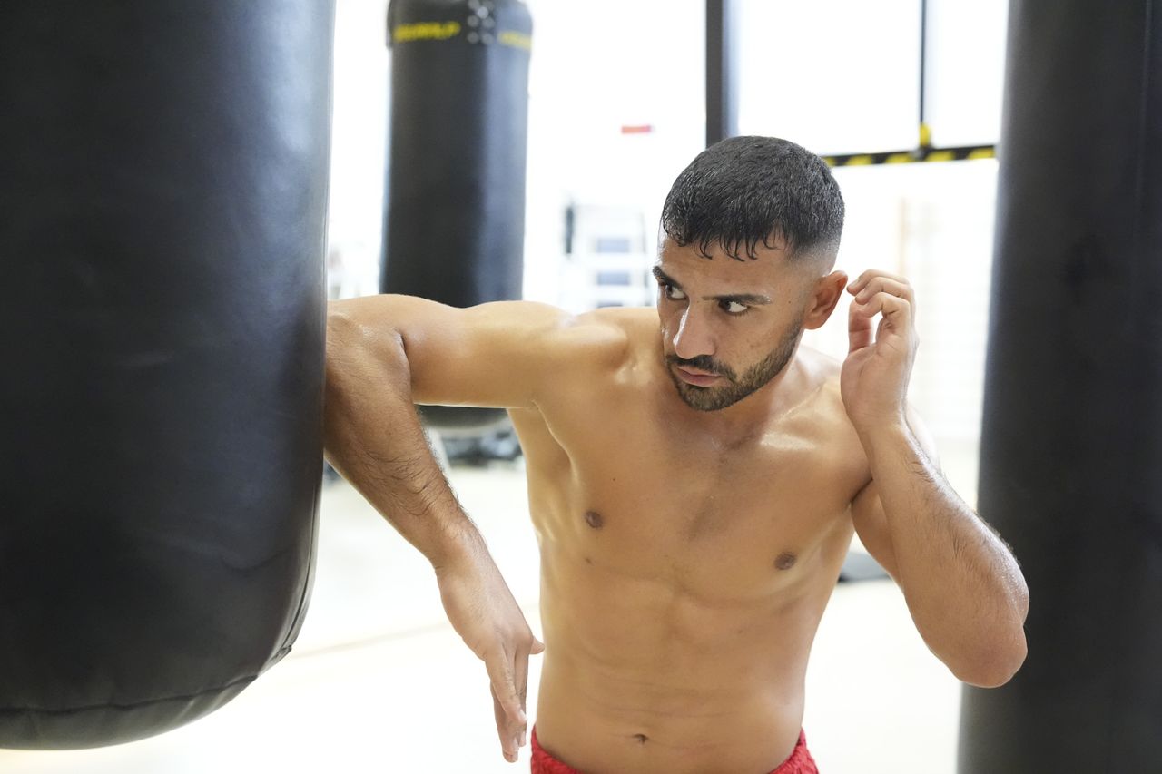 Olympic athlete in training using a punching bag
