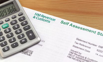 Self assessment Tax Form and a calculator on a desk