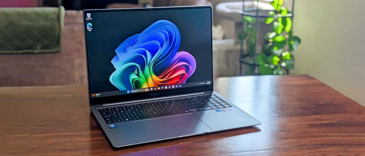 Samsung Galaxy Book5 Pro on table with a green plant behind it. 