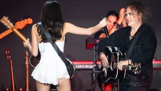 GLASTONBURY, ENGLAND - JUNE 29: (EDITORIAL USE ONLY) Olivia Rodrigo performs with Robert Smith of The Cure on the Pyramid stage during day five of Glastonbury festival 2025 at Worthy Farm, Pilton on June 29, 2025 in Glastonbury, England. Established by Michael Eavis in 1970, Glastonbury has grown into the UK's largest music festival, drawing over 200,000 fans to enjoy performances across more than 100 stages. In 2026, the festival will take a fallow year, a planned pause to allow the Worthy Farm site time to rest and recover. (Photo by Samir Hussein/WireImage)
