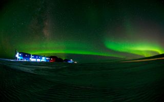 Green auroras dance over the Halley Research Station in Antarctica, where scientists will practice space docking simulations as part of a human spaceflight study.
