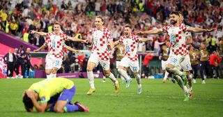Croatia players celebrate their win via a penalty shootout as Marquinhos of Brazil react during the FIFA World Cup Qatar 2022 quarter final match between Croatia and Brazil at Education City Stadium on December 09, 2022 in Al Rayyan, Qatar.