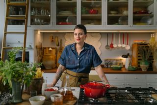 portrait of chef standing in kitchen