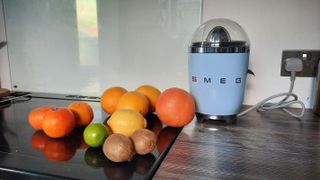 Smeg CJF01 citrus juicer with a variety of citrus fruit to test