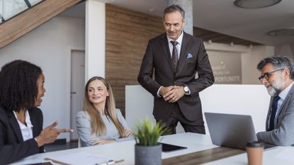 Financial advisers have a meeting in a conference room.