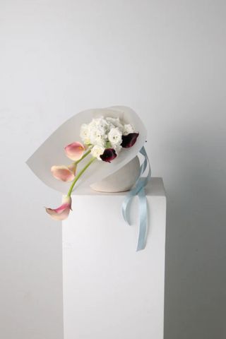 minimalist flower arrangement on a pedestal