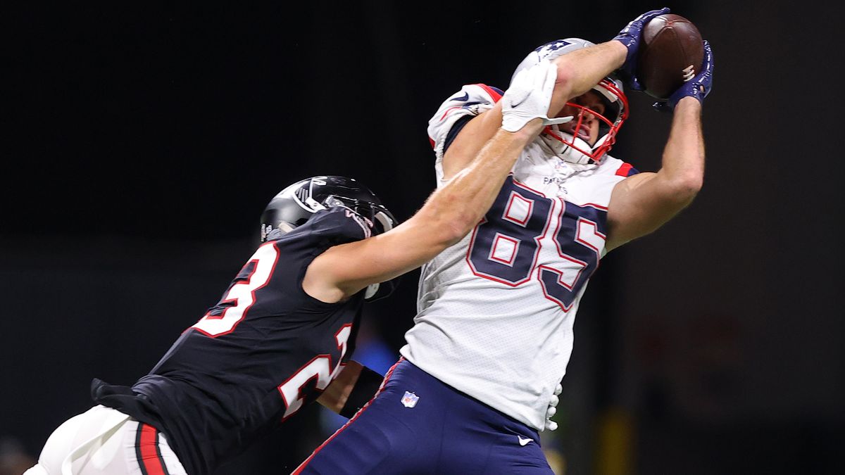 Hunter Henry #85 of the New England Patriots makes a catch over Erik Harris #23 of the Atlanta Falcons in the third quarter at Mercedes-Benz Stadium on Nov. 18, 2021 in Atlanta, Georgia.