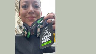 Jen Barton holding Saucony 10km medal at 2024 finish line