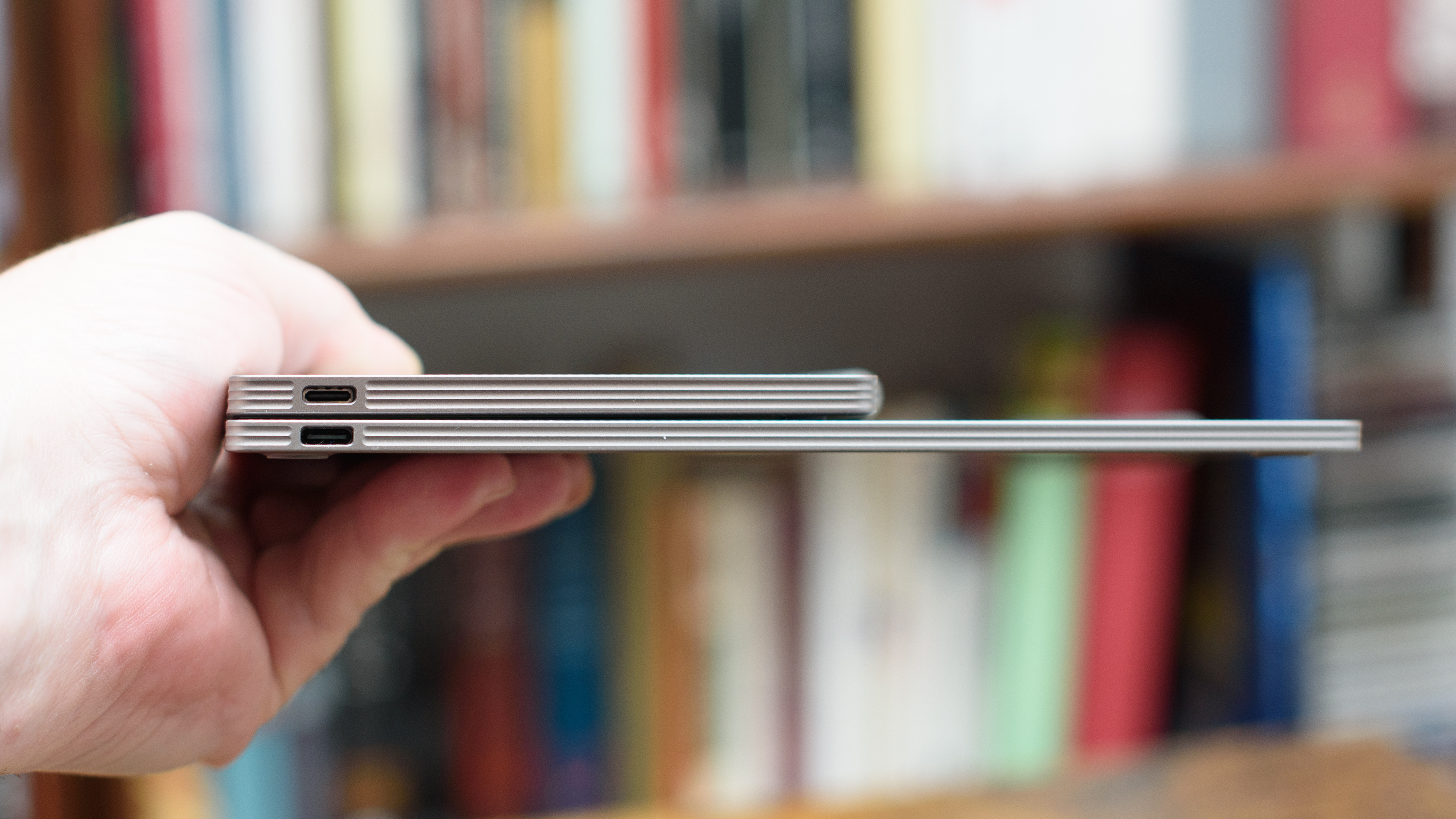 reMarkable Paper Pro Move tablet in front of a library of books, showing various writing screens and comparing the size to a Moleskine notebook