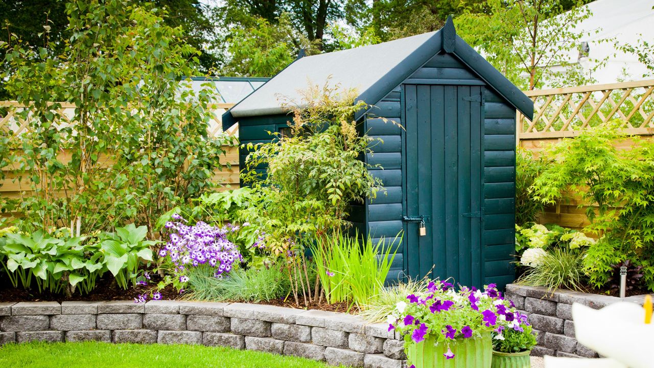 green garden shed in back garden gettyimages_166416466