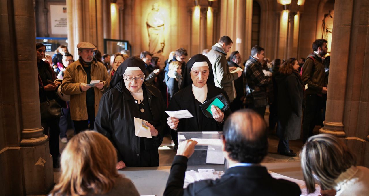 Nuns cast their ballot papers at a polling station in Barcelona