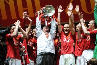 Sir Alex Ferguson celebrates with the Champions League trophy after Manchester United's win against Chelsea on penalties in the 2008 final.