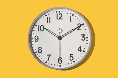 Wall clock showing 10:10 on a yellow background. Time, hour, minute, second, measuring instrument.