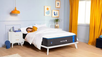 One of the best mattress deals is the Nectar Foam Mattress, seen here with someone sleeping on it