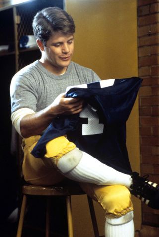 sean astin wears football gear in the movie rudy