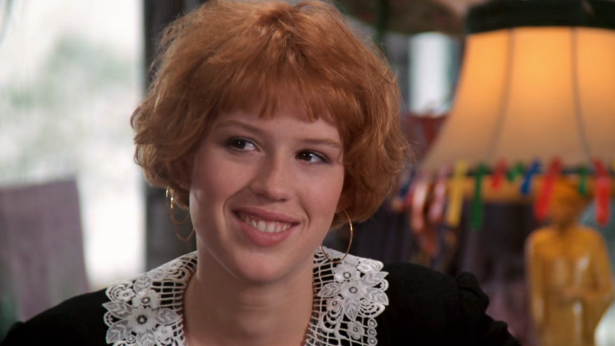 A close up of Molly Ringwald smiling in Pretty in Pink