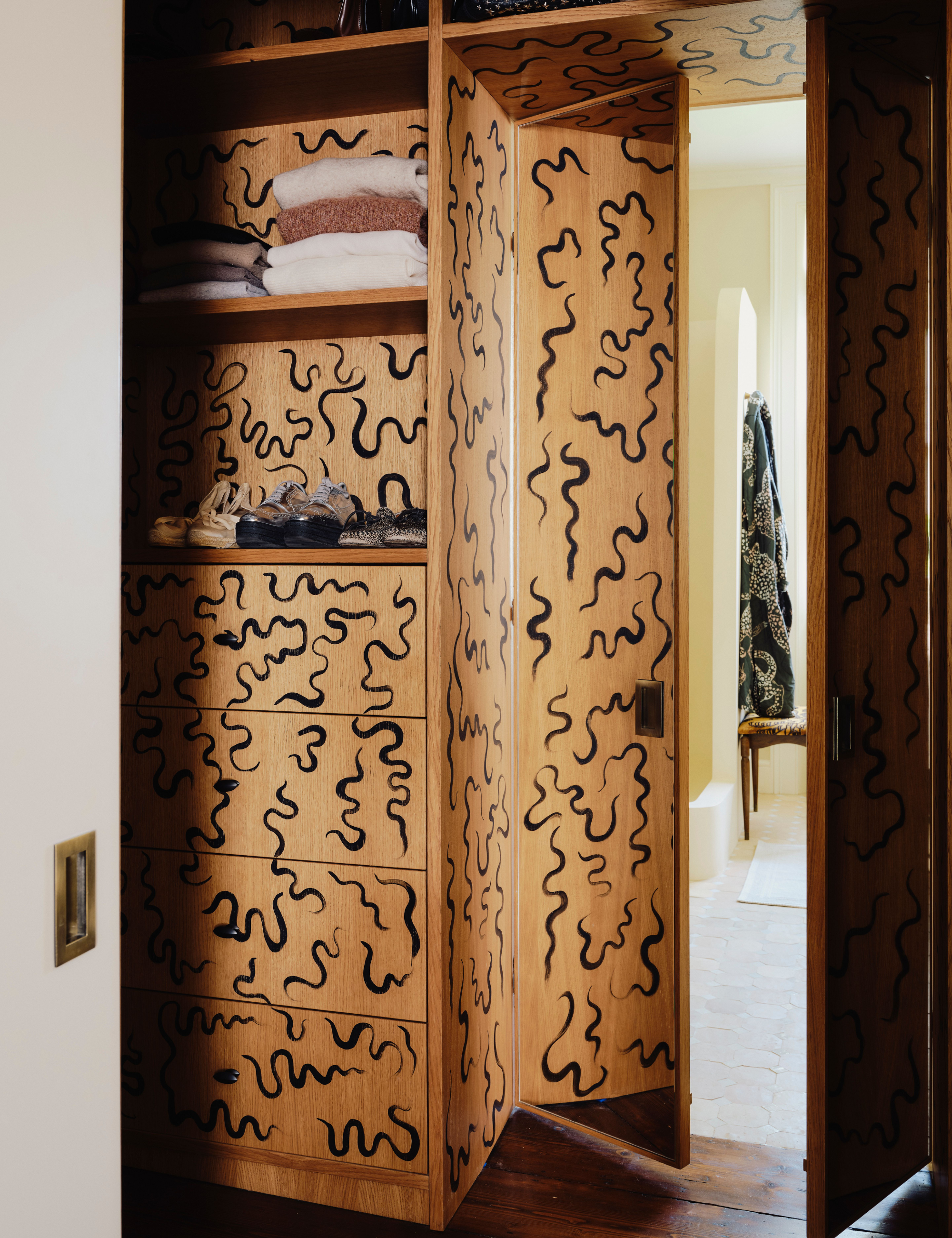 Hand-pained built-in storage shelving inside of a master bedroom dressing room
