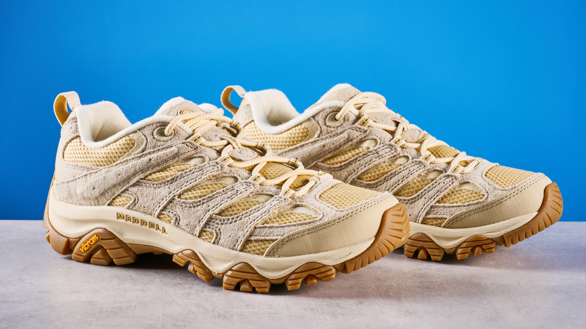 the merrell moab 3 photographed against a blue tom's guide background