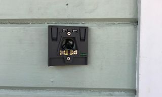 The existing doorbell wires actually attach to the bracket, and then the doorbell camera unit clicks onto the front, with two security screws up top.