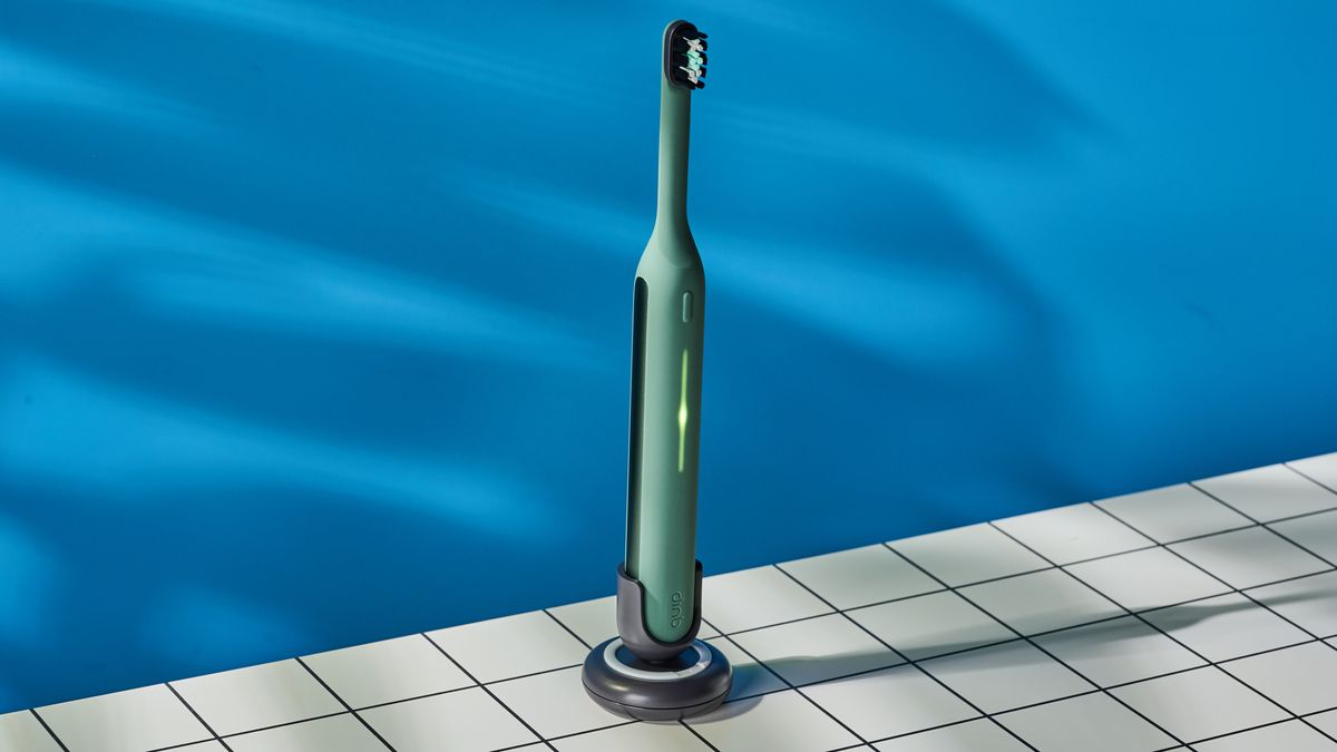 Quip Ultra Next Generation Smart Sonic Electric Toothbrush photographed in front of a blue background.