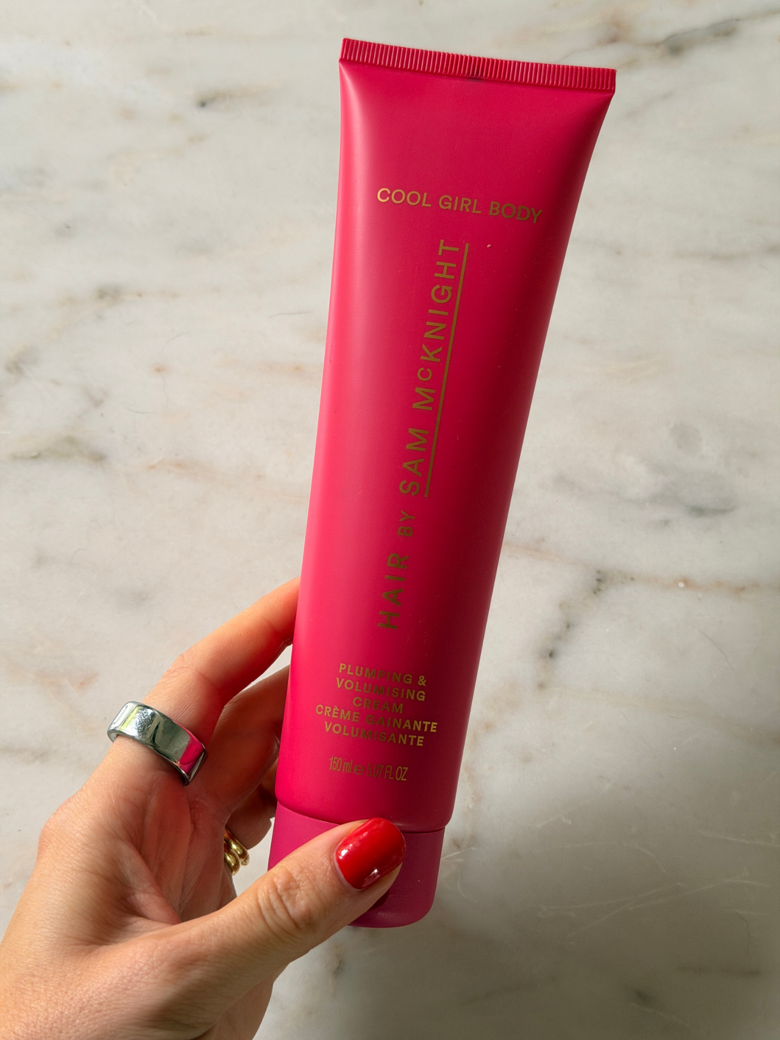 Freelance beauty editor Grace Day holding a tube of the Hair By Sam McKnight Cool Girl Body Plumping &amp;amp; Volumising Cream