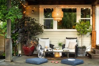 Outdoor patio with seating area, fairy lights and lantern pendant