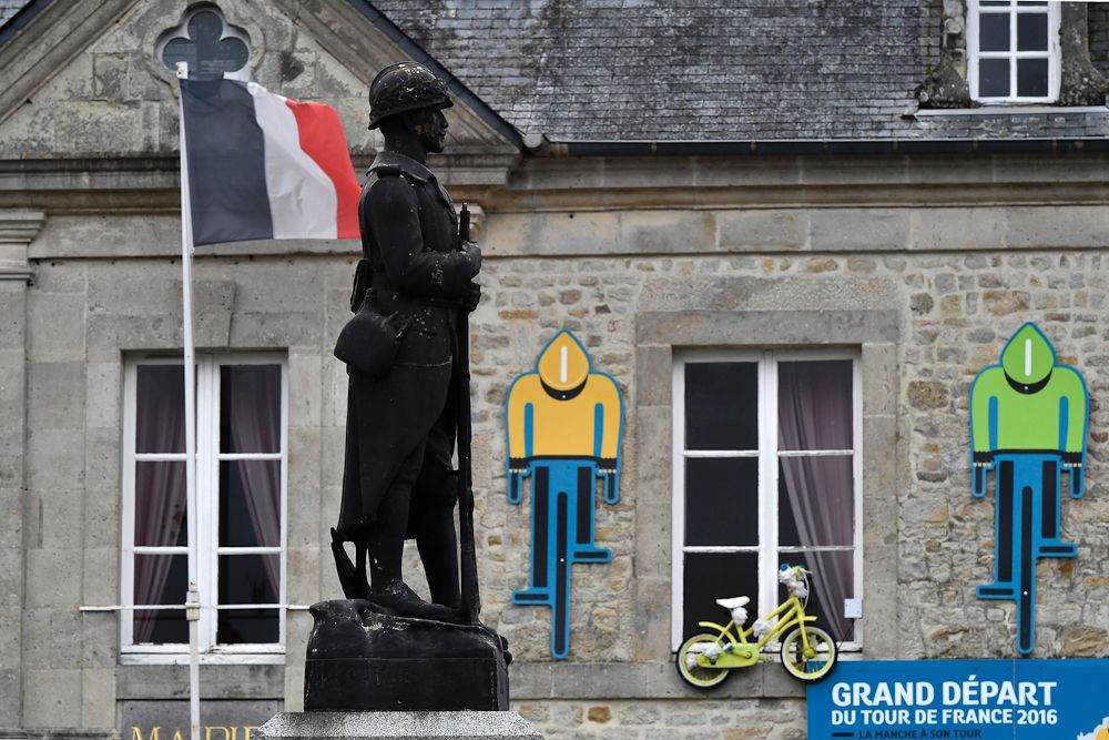 Carboard silhouettes shaped as cyclists wearing the Tour de France's colors of jersey are installed on the facade of the city hall of in Sainte-Marie-du-Mont