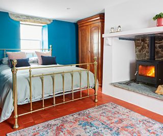bedroom with inglenook fireplace and log burning stove