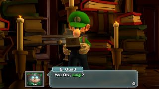 Luigi looking at a DS-like device in Luigi's Mansion 2 HD.