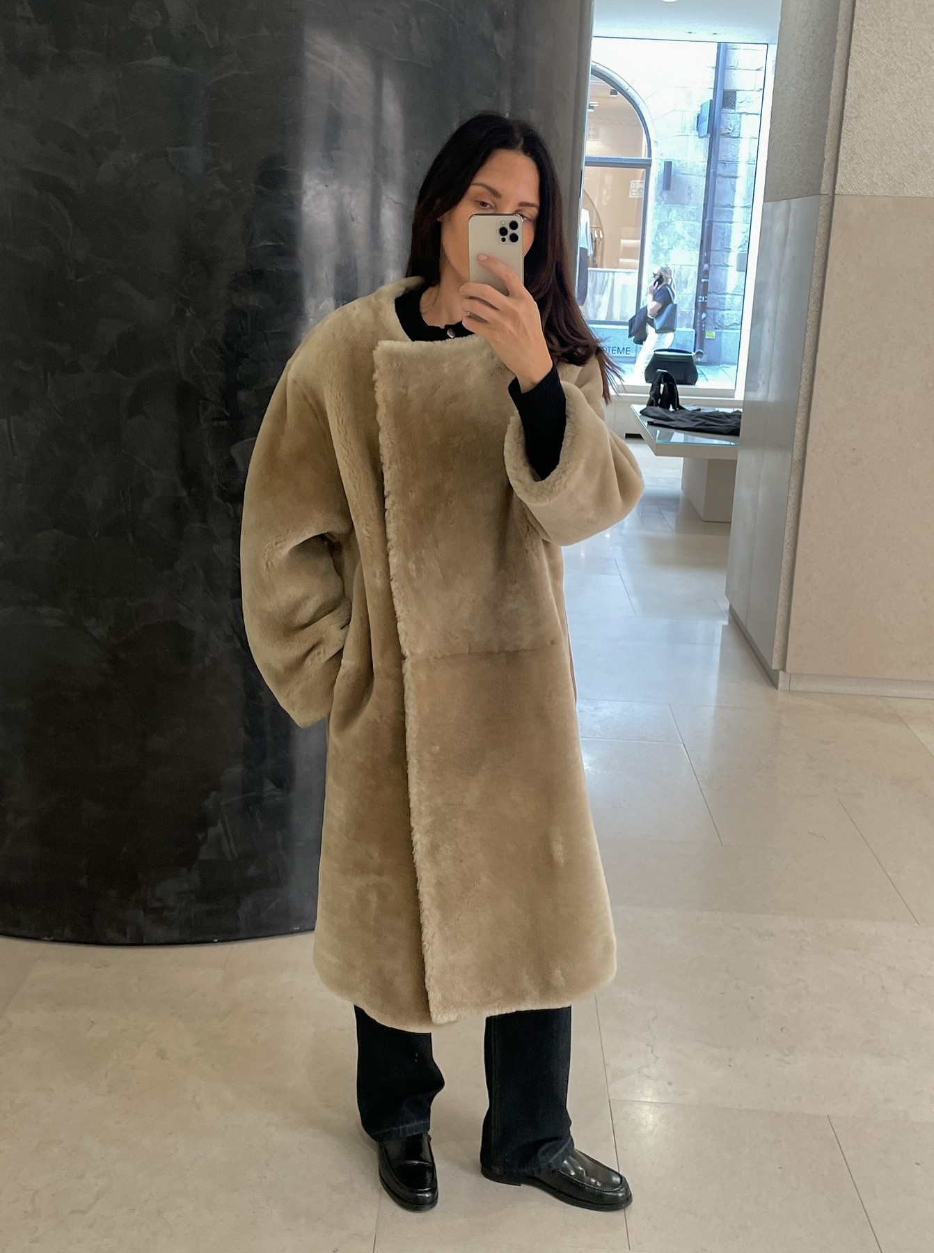 @johannapiispa wears a collarless shearling coat from Toteme with black trousers and leather loafters.
